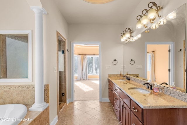 bathroom featuring plus walk in shower, decorative columns, tile patterned floors, and vanity