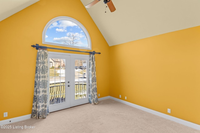 unfurnished room with carpet flooring, high vaulted ceiling, ceiling fan, and french doors