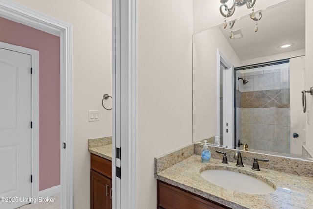 bathroom featuring vanity and a tile shower