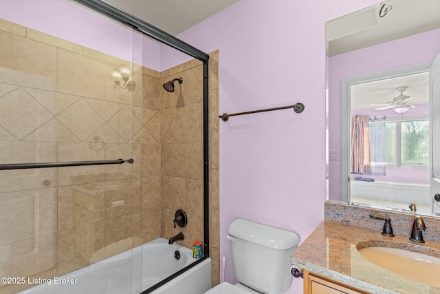 full bathroom featuring shower / bath combination with glass door, vanity, and toilet