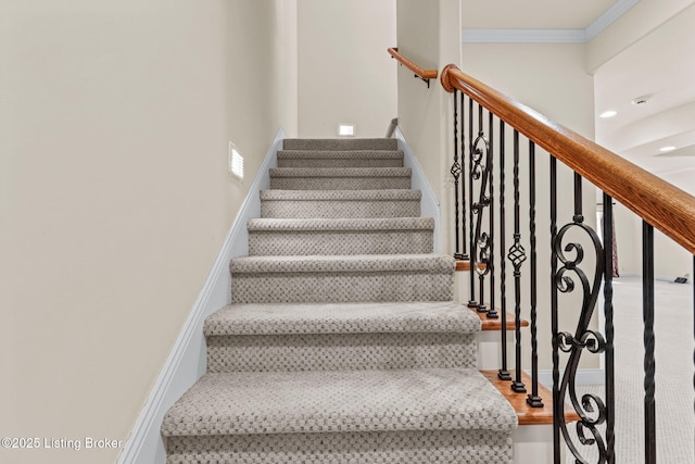 stairway featuring ornamental molding