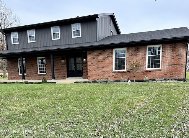 view of front of house with french doors and a front lawn