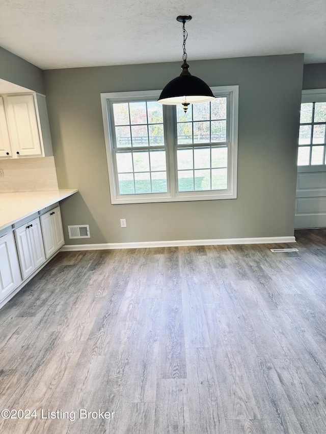 unfurnished dining area with light hardwood / wood-style flooring