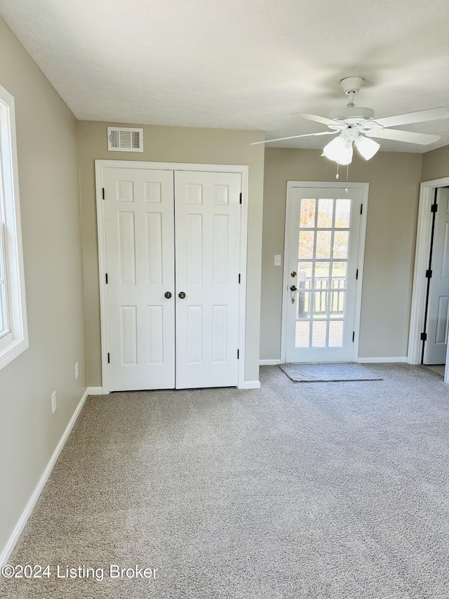 unfurnished bedroom featuring carpet floors, a closet, ceiling fan, and access to outside