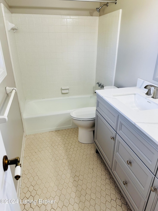 full bathroom with toilet, vanity, and tiled shower / bath combo