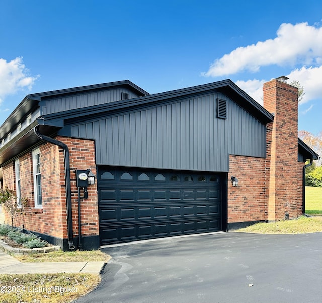 view of side of home with a garage