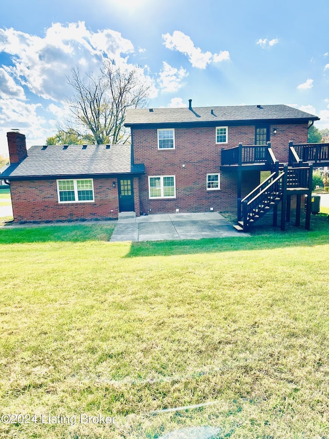 back of property featuring a patio area, a lawn, and a deck