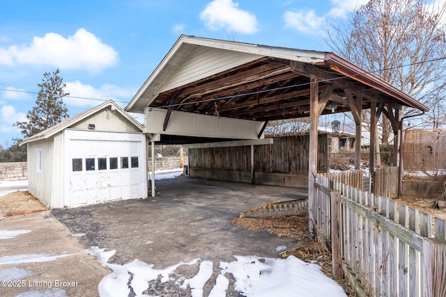 exterior space with a garage, an outbuilding, and a carport