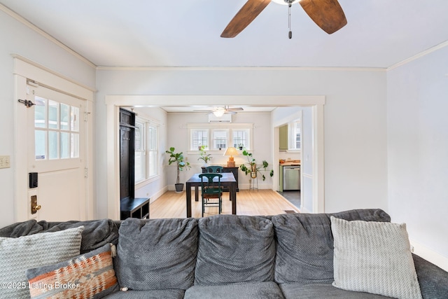 living room with light hardwood / wood-style floors, crown molding, and ceiling fan