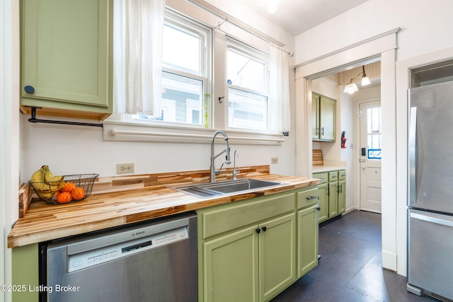 kitchen featuring sink, plenty of natural light, green cabinetry, wood counters, and stainless steel appliances