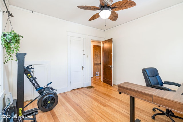 office with ceiling fan, crown molding, and light hardwood / wood-style floors