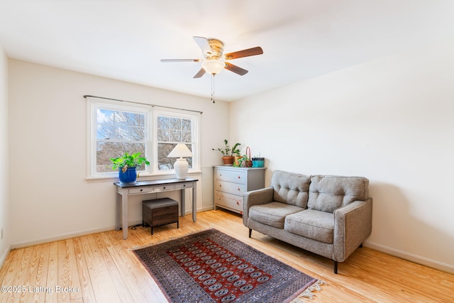 sitting room with ceiling fan and light hardwood / wood-style flooring