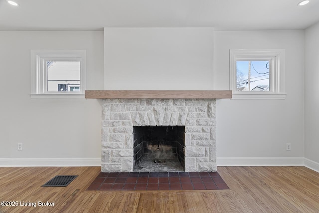 interior details with a fireplace and wood-type flooring