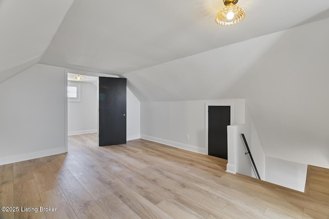 bonus room featuring vaulted ceiling and light wood-type flooring