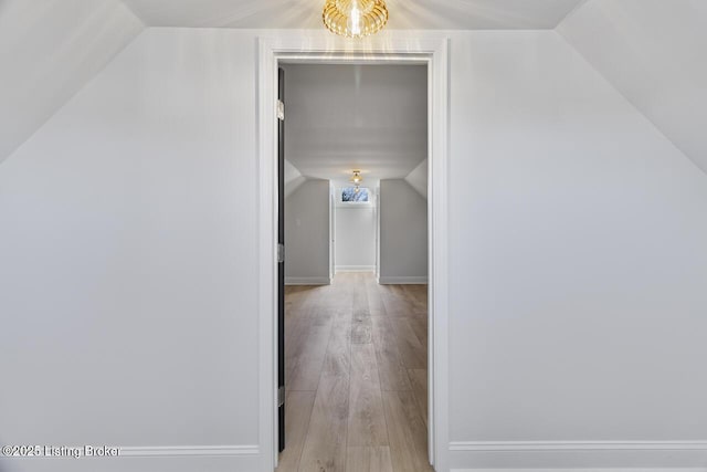 bonus room featuring light hardwood / wood-style floors and lofted ceiling