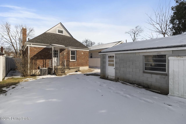 view of front of property featuring central AC and a garage