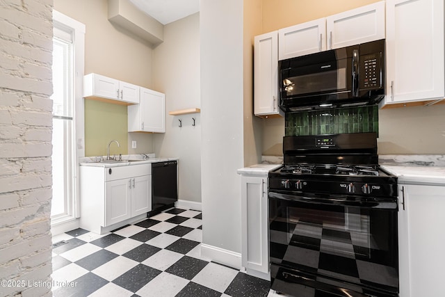 kitchen featuring sink, black appliances, and white cabinets