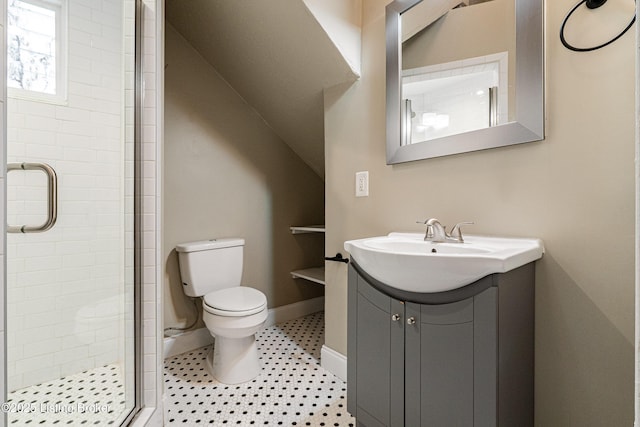 bathroom featuring vanity, toilet, and a shower with door