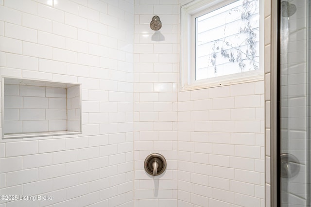 bathroom with a tile shower