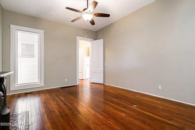 empty room featuring ceiling fan and dark hardwood / wood-style floors