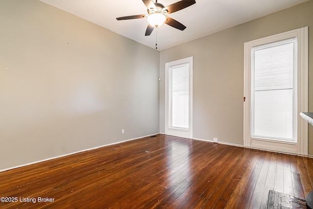 empty room with ceiling fan and dark wood-type flooring