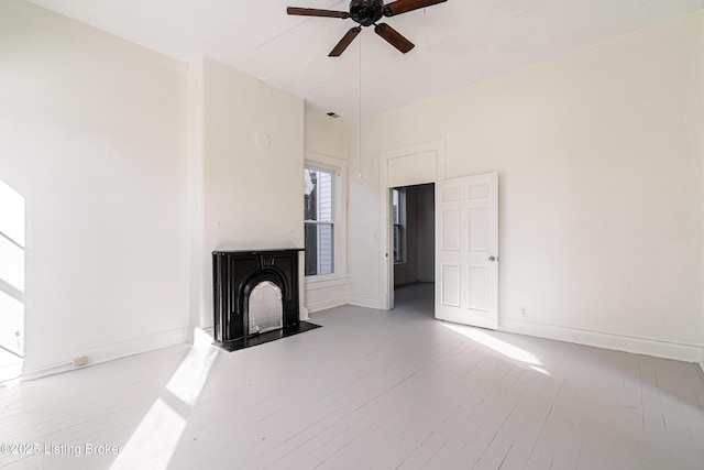 unfurnished living room with light hardwood / wood-style flooring and ceiling fan