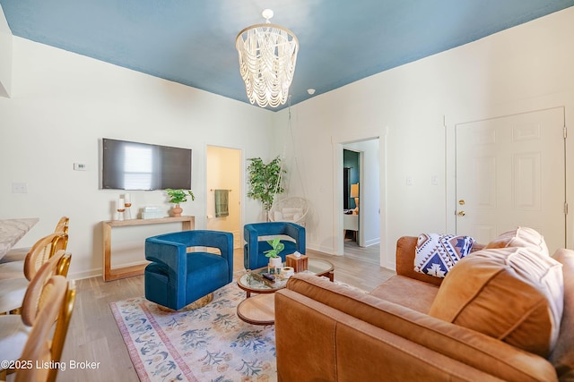 living room with light hardwood / wood-style floors and a chandelier