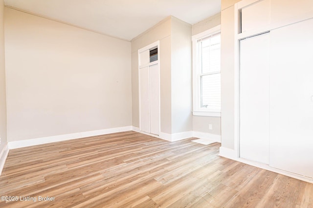 unfurnished bedroom with light wood-type flooring