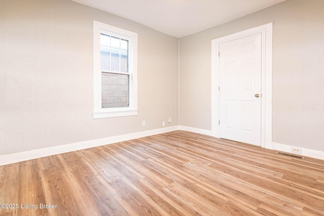 spare room with light hardwood / wood-style floors