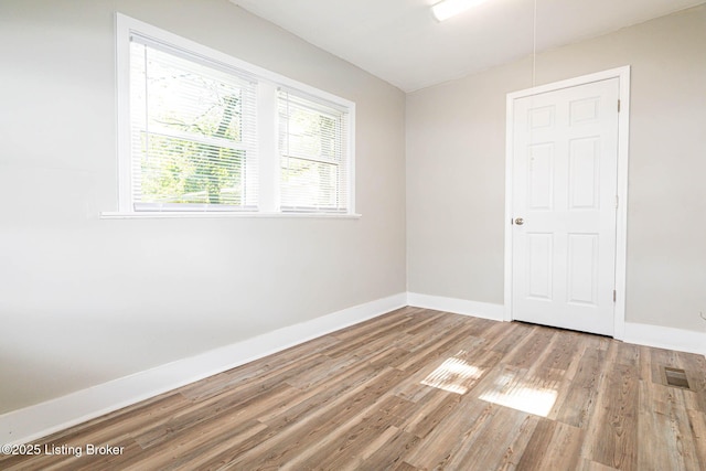 empty room with light hardwood / wood-style flooring