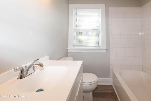 full bathroom with vanity, toilet, hardwood / wood-style floors, and tiled shower / bath