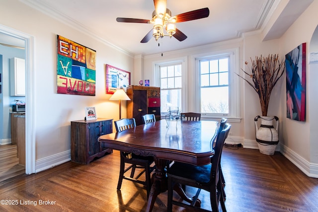 dining room featuring dark hardwood / wood-style flooring, ornamental molding, and ceiling fan