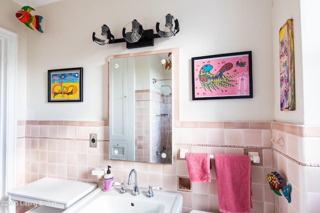 bathroom with tile walls, sink, and a shower