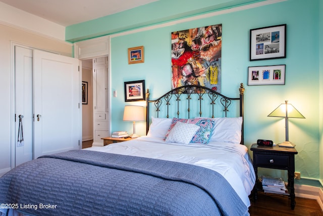 bedroom featuring hardwood / wood-style floors and a closet