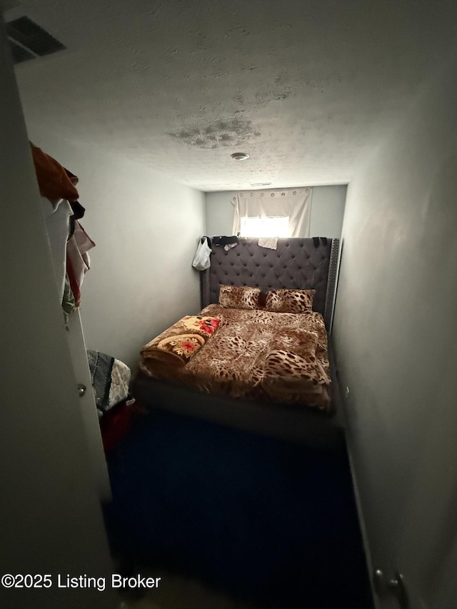 carpeted bedroom featuring a textured ceiling