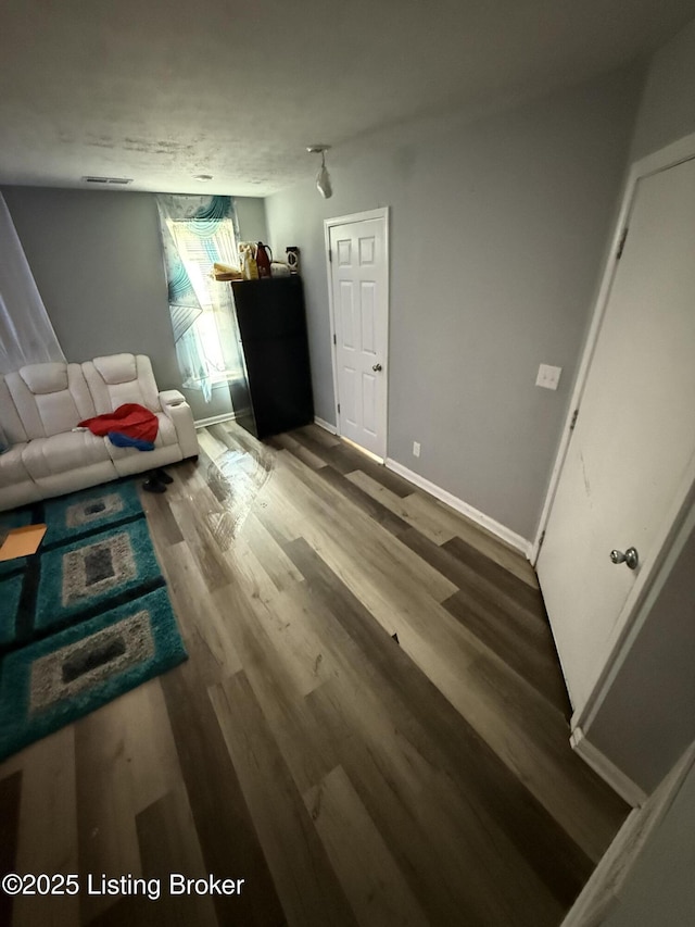 unfurnished living room featuring hardwood / wood-style floors