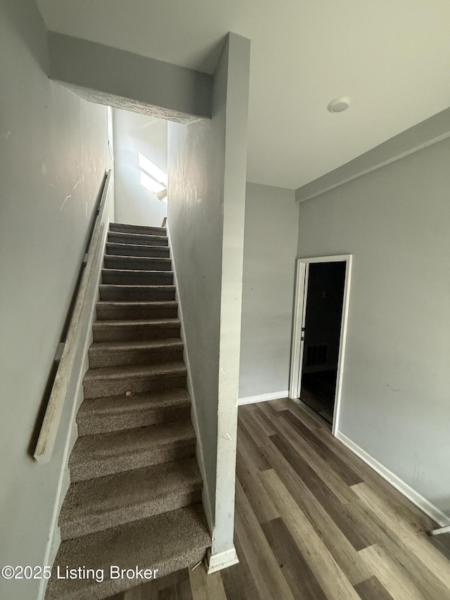 staircase featuring hardwood / wood-style floors