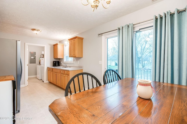 dining area featuring sink and a textured ceiling