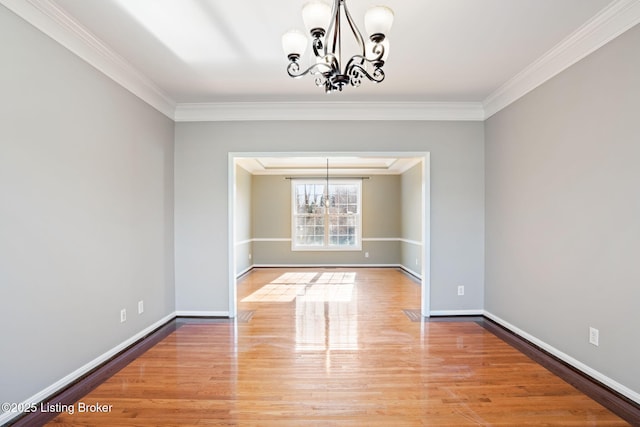 unfurnished dining area with crown molding and a notable chandelier