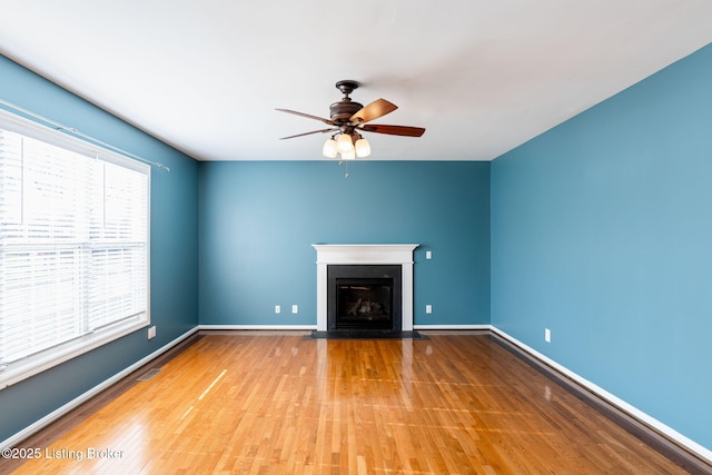 unfurnished living room featuring light hardwood / wood-style floors and ceiling fan