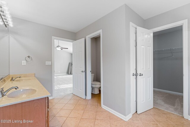 bathroom with toilet, tile patterned flooring, and vanity