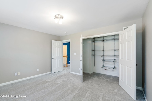 unfurnished bedroom with light carpet and a closet