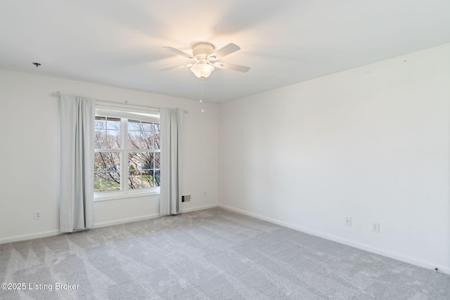 empty room featuring ceiling fan and light carpet