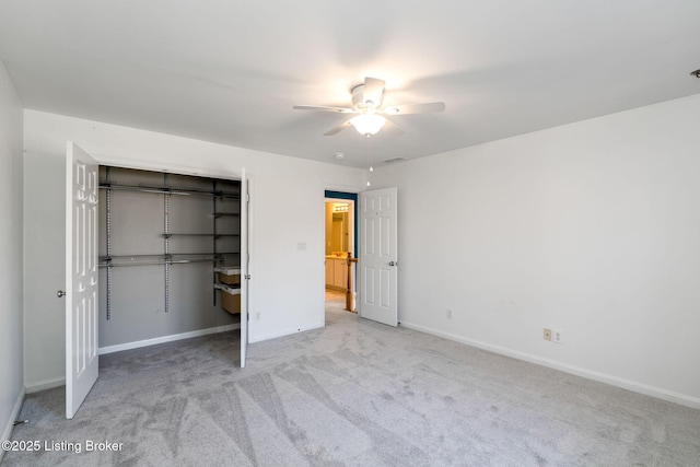 unfurnished bedroom featuring a closet, ceiling fan, and light carpet