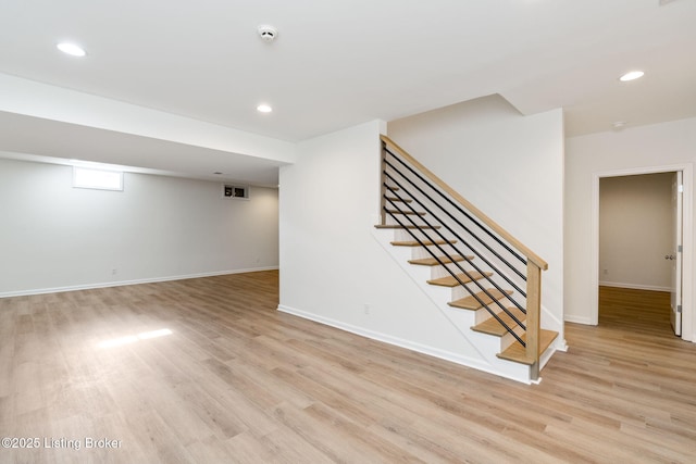 basement featuring light wood-type flooring