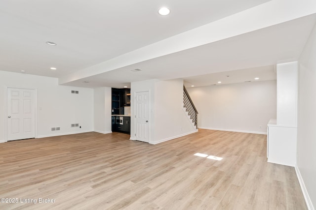 basement with light hardwood / wood-style floors