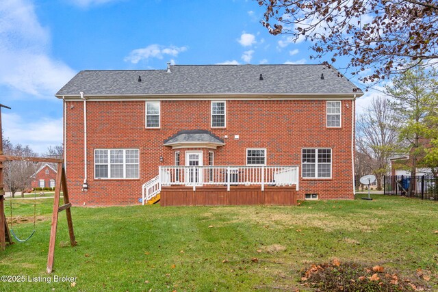 back of property featuring a yard and a deck