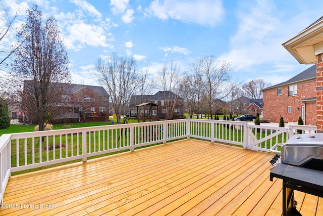 deck with a lawn and grilling area