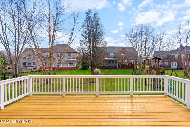 wooden deck featuring a lawn