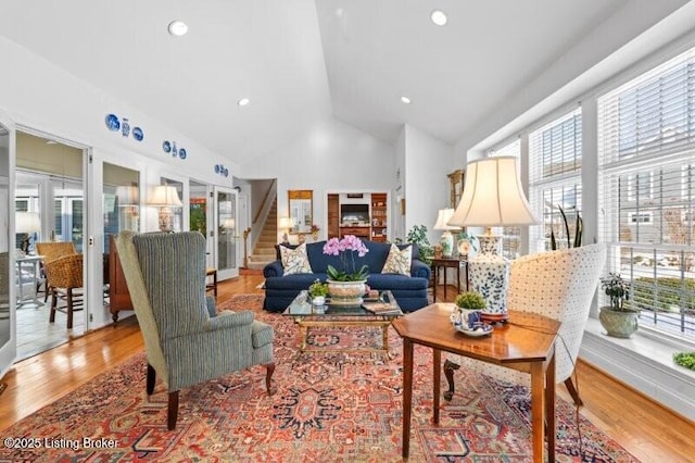 living room featuring recessed lighting, stairway, high vaulted ceiling, and wood finished floors